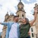 Latin American couple looking very happy sightseeing in Bogota at the Plaza de Bolivar - travel concepts