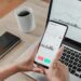 Forex trader using crypto exchange mobile phone app for investment and stock market analysis at hedge fund office - Focus on screen
