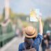 Female tourists on hand have a happy travel map.