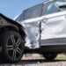 Damaged in heavy car accident vehicles after collision on city street crash site. Road safety and insurance concept.