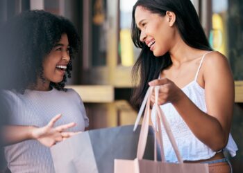 Women, shopping bag and retail promotion conversation in shopping market street for luxury fashion,.