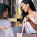 Women, shopping bag and retail promotion conversation in shopping market street for luxury fashion,.