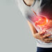 Woman touching stomach painful suffering from stomachache causes of menstruation period, gastric ulcer, appendicitis or gastrointestinal system disease. Healthcare and health insurance concept.