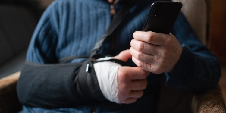 Detailed view of elderly man's hand using smartphone