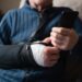 Detailed view of elderly man's hand using smartphone