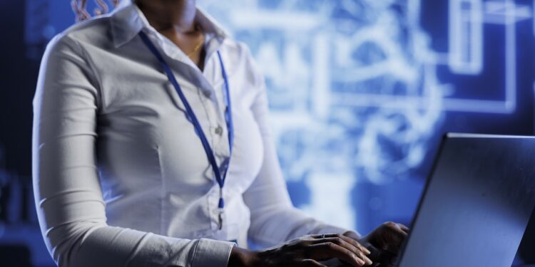 Certified technician developing artificial intelligence neural networks nodes modeled after human brain. Experienced worker setting up AI machine learning accurately making predictions using data
