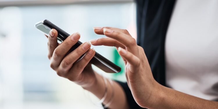 Cropped shot of an unrecognizable woman using her cellphone