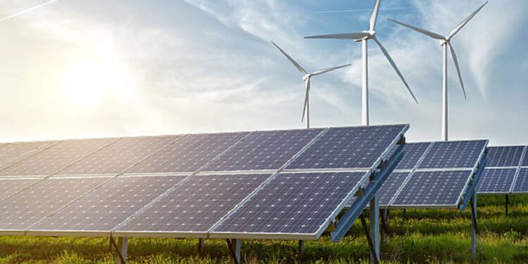 solar panels and wind generators under blue sky on sunset