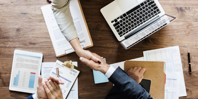 Business people shaking hands together