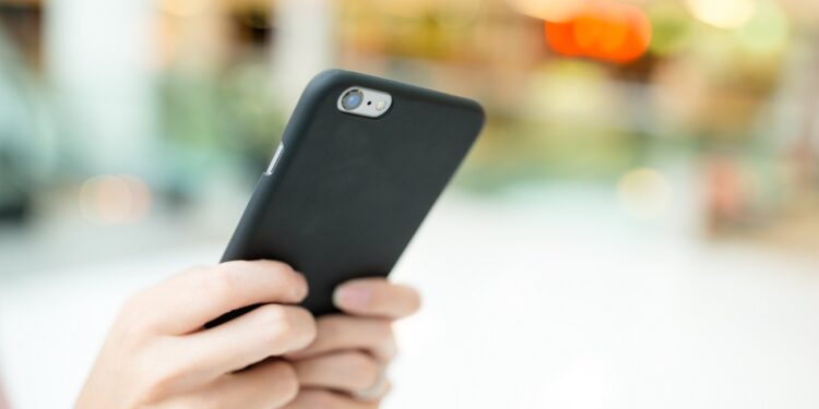 Woman sending sms on cellphone