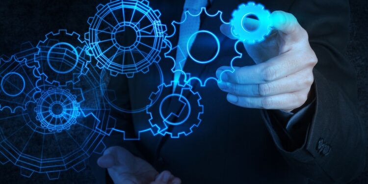 businessman hand touch blue gear to success concept