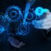 businessman hand touch blue gear to success concept