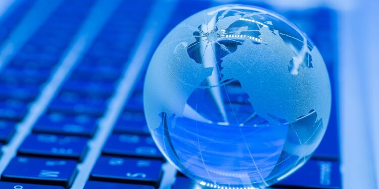 The business concept of the glass world on a laptop keyboard