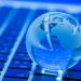 The business concept of the glass world on a laptop keyboard