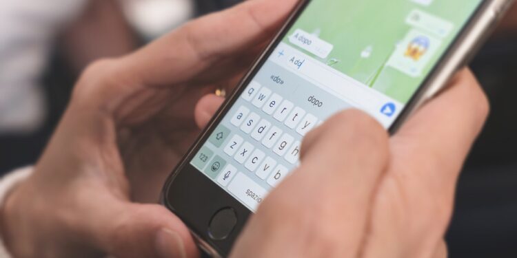 Woman hands using smartphone typing, chatting conversation in chat box icons pop up. Social media maketing technology concept. Vintage soft color tone background.