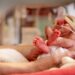 A Closeup of a hand of a premature newborn baby in incubator
