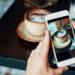 Female blogger taking photo of her coffee to make a post