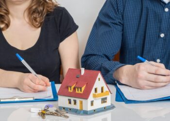 Divorce and dividing a property concept. Man and woman are signing divorce agreement.