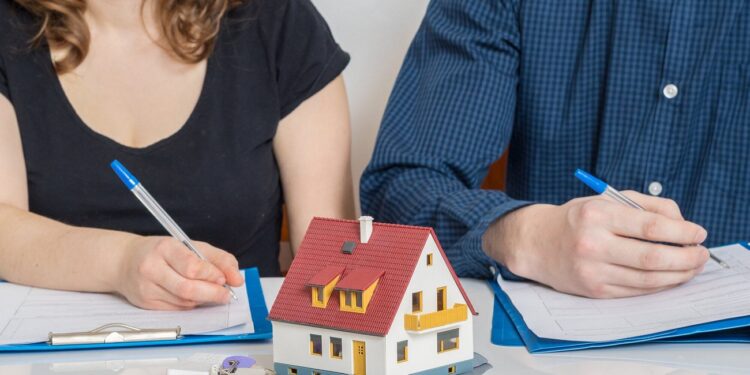 Divorce and dividing a property concept. Man and woman are signing divorce agreement.