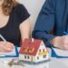 Divorce and dividing a property concept. Man and woman are signing divorce agreement.
