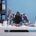 Extremely fatigued office person suffering from burnout syndrome showing thumbs up to coworkers for doing a good job. Exhausted businessman falling asleep because of overwork while showing OK symbol.