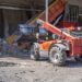 A loader transporting soil and waste materials at a waste treatment plant