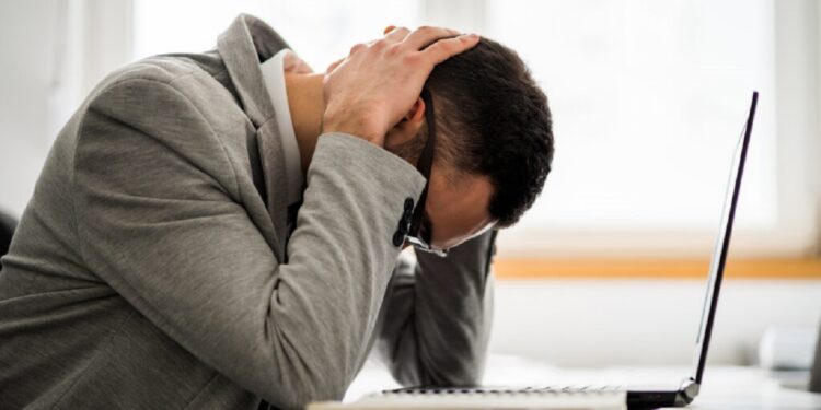Young businessman is tired of overwork. He is depressed.