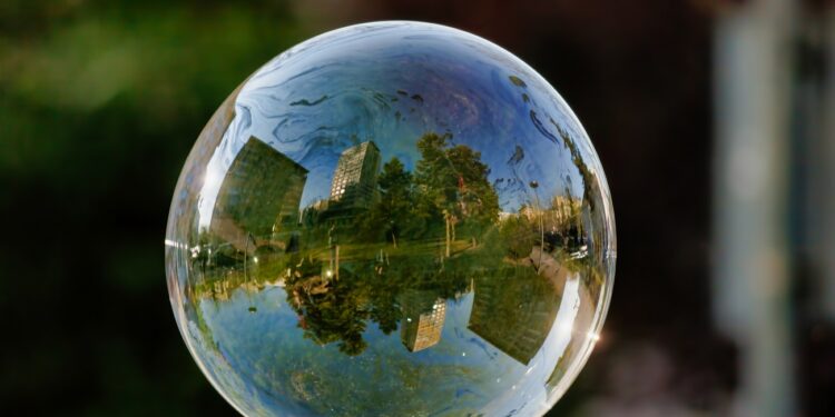 A soft focus of a bubble with reflection of city buildings and trees on it