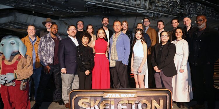 ANAHEIM, CALIFORNIA - DECEMBER 02: (L-R) John Knoll, Dave Filoni, Chief Creative Officer, Lucasfilm, Jaleel White, Nick Frost, Jon Favreau, Ravi Cabot-Conyers, Kathleen Kennedy, President, Lucasfilm, Ryan Kiera Armstrong, Jon Watts, Jude Law, Bryce Dallas Howard, Kyriana Kratter, Lee Isaac Chung, Christopher Ford, Jake Schreier, Robert Timothy Smith, Chris Buongiorno, Alia Shawkat, David Lowery and Tunde Adebimpe attend the Star Wars: Skeleton Crew launch event at Disneyland on December 02, 2024 in Anaheim, California. (Photo by Leon Bennett/Getty Images for Disney)