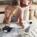 Couple facing debt problems, not able to pay out their mortgage. Thoughtful woman looking frustrated, holding pen while managing family budget, making calculations using calculator and notebook pc