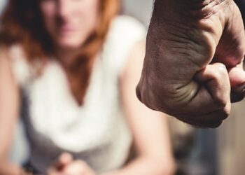 Woman is in Fear Of Domestic Abuse as her partner is making a fist