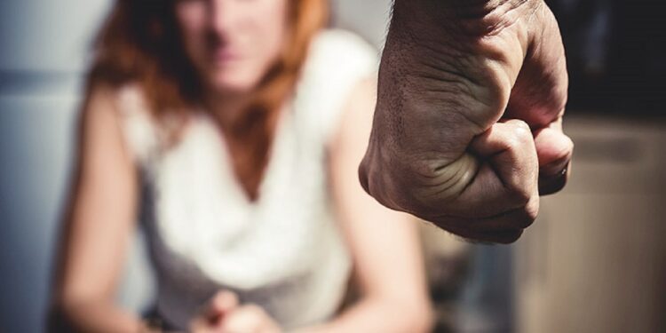 Woman is in Fear Of Domestic Abuse as her partner is making a fist