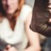 Woman is in Fear Of Domestic Abuse as her partner is making a fist