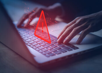 System hacked warning alert on notebook (Laptop). Cyber attack on computer network, Virus, Spyware, Malware or Malicious software. Cyber security and cybercrime. Compromised information internet.