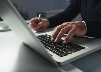Close-up image of businessman working on laptop at his table