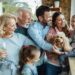 Cheerful multi-generation family with a dog having fun while spending time together at home.