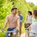 Four people with an active lifestyle, cycling on a path while wearing our brand's apparel