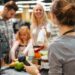 Cheerful family standing at the cash counter buying groceries at the supermarket