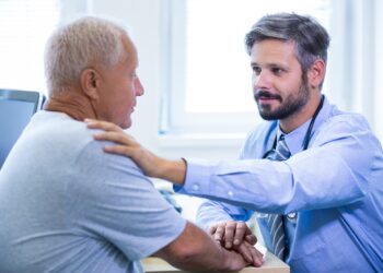 Male doctor examining a patient at the hospital
