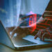 human hand using computer to surf the internet  There are security systems to protect against hackers, business ideas, internet, network security.