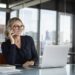 Businesswoman sitting in office, talking on the phone