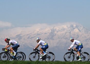 SALASSA ITALY - MARCH 13: (L-R) Tom Paquot of Belgium and Team Intermarche - Wanty, Julien Simon of France and Valentin Ferron of France and Team TotalEnergies compete with the Alps in the background during the 105th Milano-Torino 2024 a 177km one day race from Rho to Salassa 346m on March 13, 2024 in Salassa, Italy. (Photo by Dario Belingheri/Getty Images)