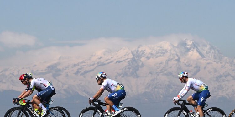 SALASSA ITALY - MARCH 13: (L-R) Tom Paquot of Belgium and Team Intermarche - Wanty, Julien Simon of France and Valentin Ferron of France and Team TotalEnergies compete with the Alps in the background during the 105th Milano-Torino 2024 a 177km one day race from Rho to Salassa 346m on March 13, 2024 in Salassa, Italy. (Photo by Dario Belingheri/Getty Images)