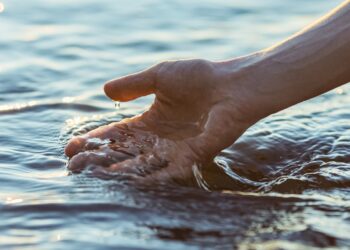Hand touching water.