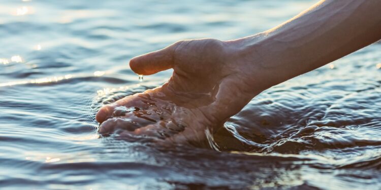 Hand touching water.