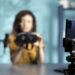Focus on smartphone used by tech vlogger to review VR glasses in studio. Close up of phone used by woman filming virtual reality headset presentation vlog for technology enthusiasts