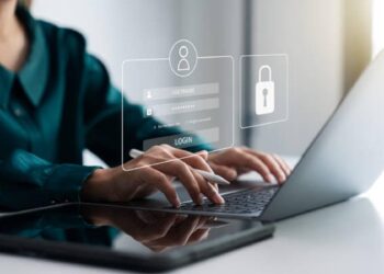Securing cybersecurity, A Businesswoman protecting personal data on laptops and virtual interfaces, Preventing Online Theft, Cybersecurity concepts.