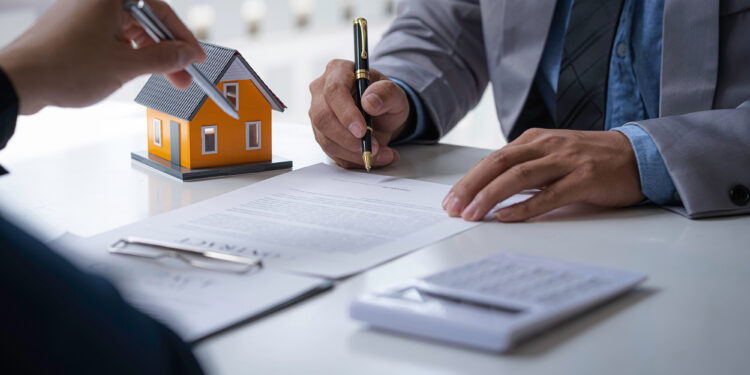 Discussion with a real estate agent, House model with agent and customer discussing for the contract to buy, get insurance or loan real estate or property.