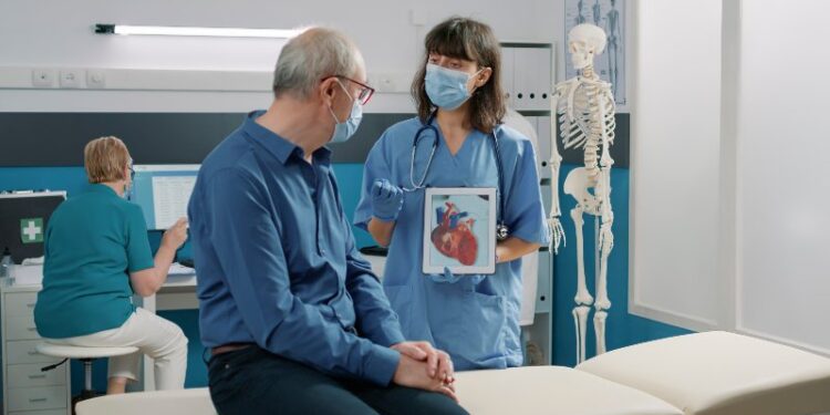 Female assistant holding tablet with cardiovascular system illustration, explaining heart condition to retired person during covid 19 pandemic. Nurse showing cardiology diagnosis on gadget. SSUCv3H4sIAAAAAAAAA02Sy27cMAxF/0XrIWq9pfmCboJ2H3RBSVTGjcce2HKDYOB/Lz2PtF4YInl0dUHyKvoijiJlq0wxDijkCEaFDAFNgoRKJjImWIXiIAo2EkepVfRKBxN8dN3+HUTCpc/ieBX9MKxLm7H10yiOXJlpLDTfjlT6Ns09DhxtB7E0bOtCC1/jKLP2G1dv8VPv9brn2eB3wqGdMs707YVlMmuwwJq49CP9ptwWsR2e8E+aLgN9AS/9kmkYcKRp/R/7AsT26yDwjcb8uXvZdtMD4c3aq7DVJCdNgWyrBWNTAAz8IyyddjnGbA1LoXGqEGO+OgUmGwnopYJaY+drcCUXxZja+WQ1dCVUVssGojMZpHNOx2hLNIkx6iwpqxK4wmMwBiOkIA1474KXFZ1ylbHQuai8yqBsJjAuJcBCHeSUpCzKVoqOMRaxXsYAKqMG06kOQvQFULPDkhTKsquhttlaX6HzkbeAb0FE9tZVMpKNa1s8Y7JmTE4T51PHy6I074kx4FRKpJPOKkrBHX3/aDSfH+Od2mnfAu79tI5t/rz3f5imCyae1bHisNBBnHBZGCiPBF+8zH3ux7fHkvBuTef7eZzaPqDbGNuU3/vyeOq+V6ees/s7V7FehonbUh7lNZ371p7hTH96+vhHb9v2F7TWcWsVAwAA