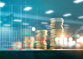 Finance and business investment concept. Graph and rows with statistic growth of coins on table.